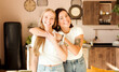 © AliceCam - Two women friends hugging at home. Adorable lesbian couple. Best friends, affectionate and happy.