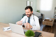 © AntonioDiaz - Video call with a Hispanic doctor working from home