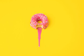 Wall Mural - pink donut on yellow background