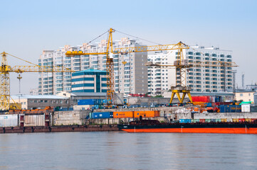 Wall Mural - Russia, Blagoveshchensk, July 2019: River station, cranes for loading operations, Blagoveshchensk in summer