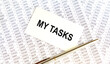© Veranika - Business concept. Notebook with text MY TASKS sheet of white paper for notes, calculator, glasses, pencil, pen, in the white background