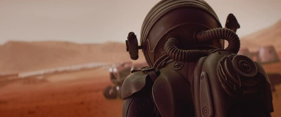 handheld tracking back view of astronaut wearing space suit walking on a surface of a red planet. ma