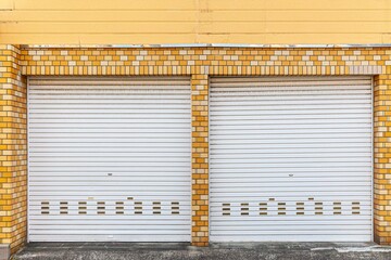 Poster - Automatic white roller shutter doors on the ground floor of the house