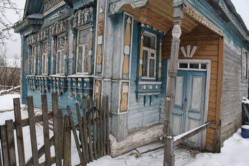 Old traditional national wooden house with richly decorated ornamental carved windows, frames in village (Moscow region, Russia). Russian folk style in architecture, countryside in Russia. Landmark