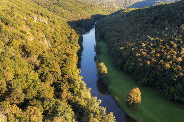 Wall Mural - Thaya river during summer or autumn time. Sunny day in the Thayatal Valley, National park, Lower Austria. Top view of the river with turns of meanders and green forests in bright sunlight. Nature 