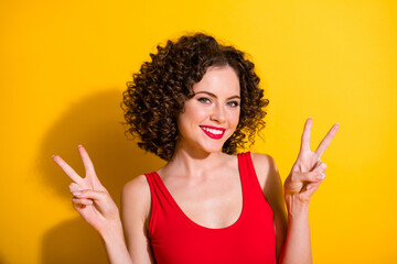 Poster - Close-up portrait of her she nice-looking attractive glamorous charming cheerful cheery wavy-haired girl showing double v-sign isolated bright vivid shine vibrant yellow color background