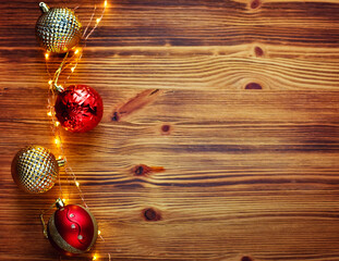 Christmas composition. Christmas red and gold decorations on a wooden background. Flat lay, top view, copy space