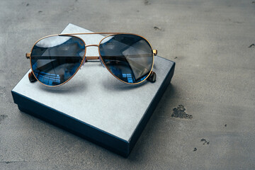 Sticker - New dark aviator glasses on grey concrete background