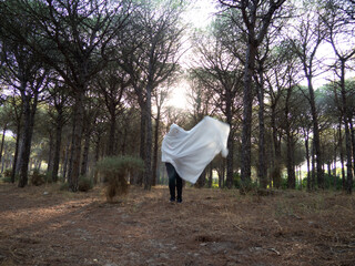 Poster - Man dressed as a ghost in a forest celebrating Halloween