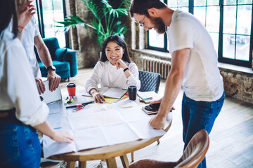 Wall Mural - Cheerful colleagues having meeting in modern workspace