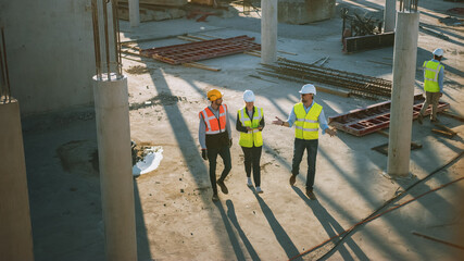 Wall Mural - Diverse Team of Specialists Taking a Walk Through Construction Site. Real Estate Building Project with Senior Civil Engineer, Architect, General Worker Discussing Planning and Development Details.