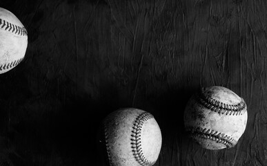 Canvas Print - Sports game dark moody background with baseball balls in black and white.