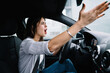 © BullRun - Young woman driving car and shouting