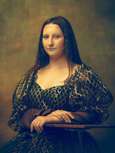 Beautiful. Young Woman As Mona Lisa, La Gioconda Isolated On Dark Green Background. Retro Style, Comparison Of Eras Concept. Beautiful Female Model Like Classic Historical Character, Old-fashioned.