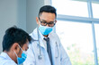© visoot - Group of doctor wearing protective surgical mask and discussing work together at the table during meeting at hospital,Epidemic virus outbreak concept.