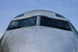 © Sue Edmondson - Nose of a grubby aeroplane with eyebrow windows, blue sky with copy space