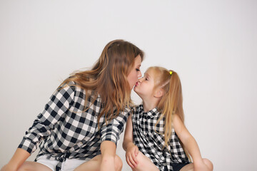 Poster - Happy loving family. Mother and her girl play, kiss and hug.