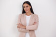 © ostap_davydiak - beautiful business lady in suit standing with arms crossed, isolated background