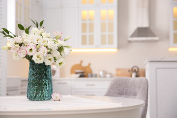 Poster - Bouquet of beautiful flowers on table in kitchen, space for text. Interior design