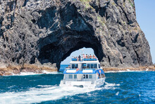 Tour Boat Entering The Hole In The Rock In Bay Of Islands, New Zealand