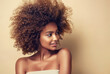 Beautiful black woman . Beauty portrait of african american woman with clean healthy skin on beige background. Smiling beautiful afro girl.Curly black hair