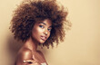 Beautiful black woman . Beauty portrait of african american woman with clean healthy skin on beige background. Smiling beautiful afro girl.Curly black hair
