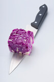 Fototapeta Tulipany - Close-up of a wedge of red cabbage on a knife