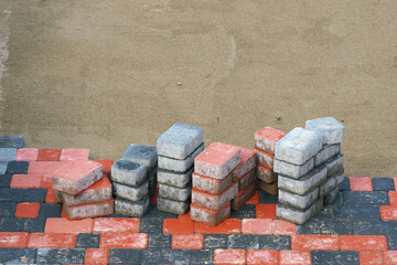 Wall Mural - Paving slabs from pressed materials of different colors and sizes. Laying artificial paving stones