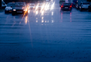 Wall Mural - slow cars traffic in the city street during downpour. looking through car windshield. motion blur