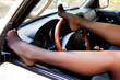 © Nobilior - Female legs on a dashboard of a car