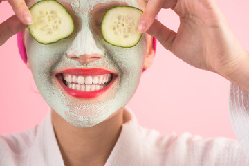 Close-up portrait of woman with facial mask. Spa salon. Cosmetic mask with cucumber. Natural beauty. Perfect skin. Woman with cucumber slices on eyes. Wellness and Spa concept.