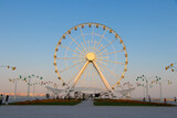 Ferris wheel on the background of blue sky. Boulevard National Park of Baku.
