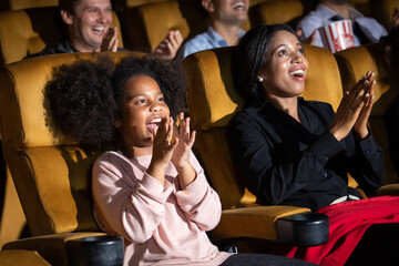 Happy family watching movie in cinema theatre. Happy family time in holiday