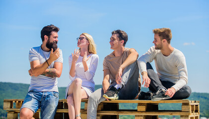 Enjoying time together. best friends. Summer vacation. happy men and girl relax. Group of people in casual wear. diverse young people talking together. group of four people. great fit for day off