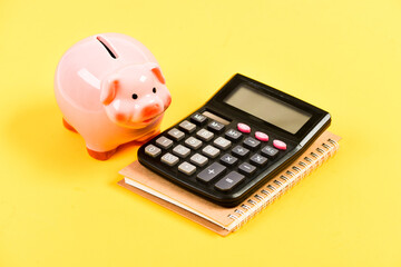 Banking account. Earn money salary. Money budget planning. Calculate profit. Piggy bank pink pig and calculator. Financial wellbeing. Economics and finance. Credit concept. Money saving. Save money