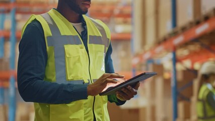 Wall Mural - Male Worker Wearing Hard Hat Checks Products Stock and Inventory with Digital Tablet Standing in Retail Warehouse full of Shelves with Goods. Distribution, Logistics. Zoom in on Tablet Computer