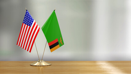 Wall Mural - American and Zambia flag pair on a desk over defocused background 