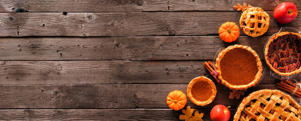 Poster - Assorted homemade autumn pies. Pumpkin, apple and pecan. Overhead view corner border on a rustic wood banner background with copy space.