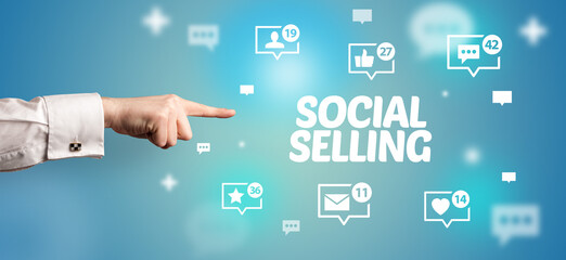 close-up of cropped hand pointing at social selling inscription, social networking concept