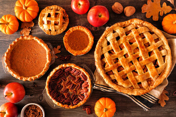 Aufkleber - Variety of homemade autumn pies. Apple, pumpkin and pecan. Top down view table scene on a rustic wood background.