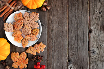 Aufkleber - Autumn leaf sugar cookies. Top view side border on a rustic wood background with copy space.