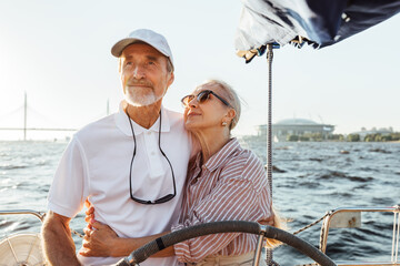 Sticker - Elderly couple embracing on a private yacht while on vacation