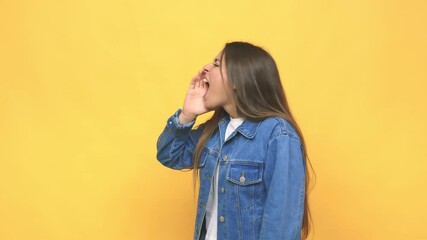 Wall Mural - Young cute woman shouting and holding palm near opened mouth