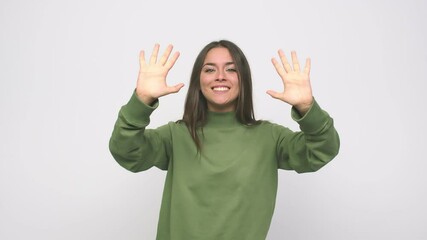 Wall Mural - Young cute woman showing number ten with hands