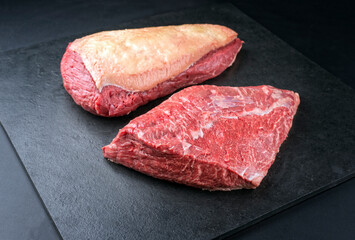 Raw dry aged wagyu cap of rump beef offered as close-up on black background with copy space