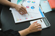 © Jirapong - A female business consultant describes a marketing plan to set business strategies for women business owners.