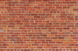 Antique grungy reddish brown brick wall texture background in a common bond brickwork pattern, with copy space