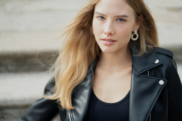 beautiful calm confident posing looking at the camera. a close portrait of a young woman lady of Caucasian appearance.