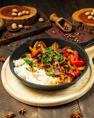 Wall Mural - Beef with vegetables and rice in cast iron pan