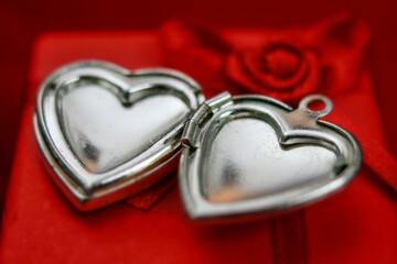 Two silver hearts on a red background